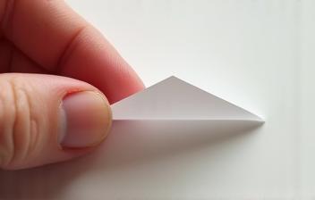 Hand peeling backing from a vignette sticker